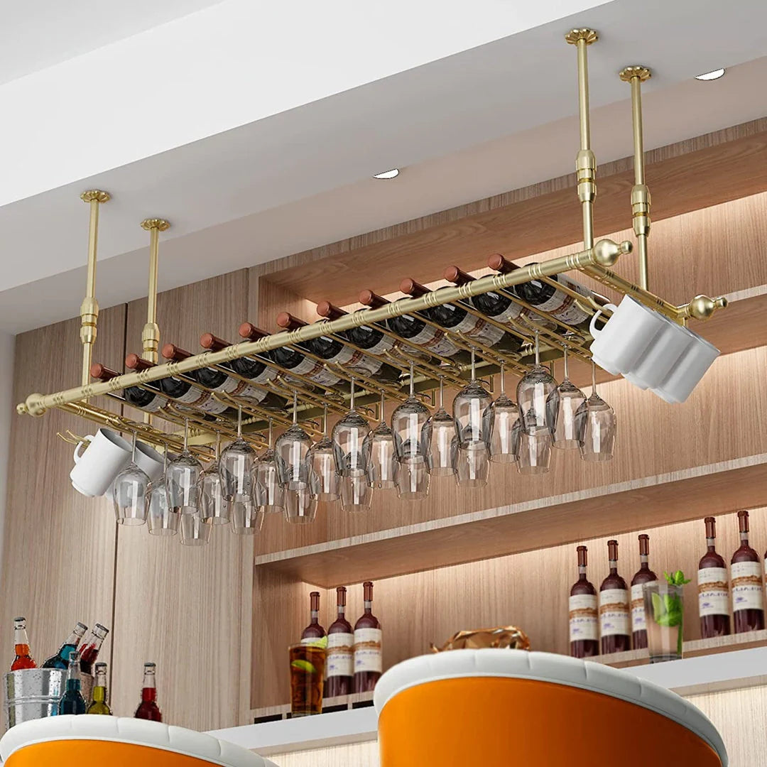 Overhead brass rack suspended above a bar, holding neatly arranged glassware and bottles, combining functional storage with an elegant, polished metal finish.