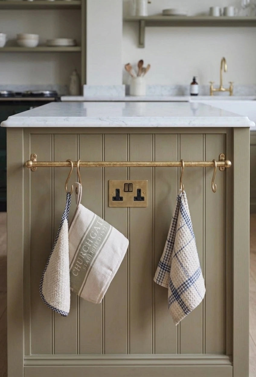 rod mounted on a kitchen wall used as  a bar for dishclothes and towels