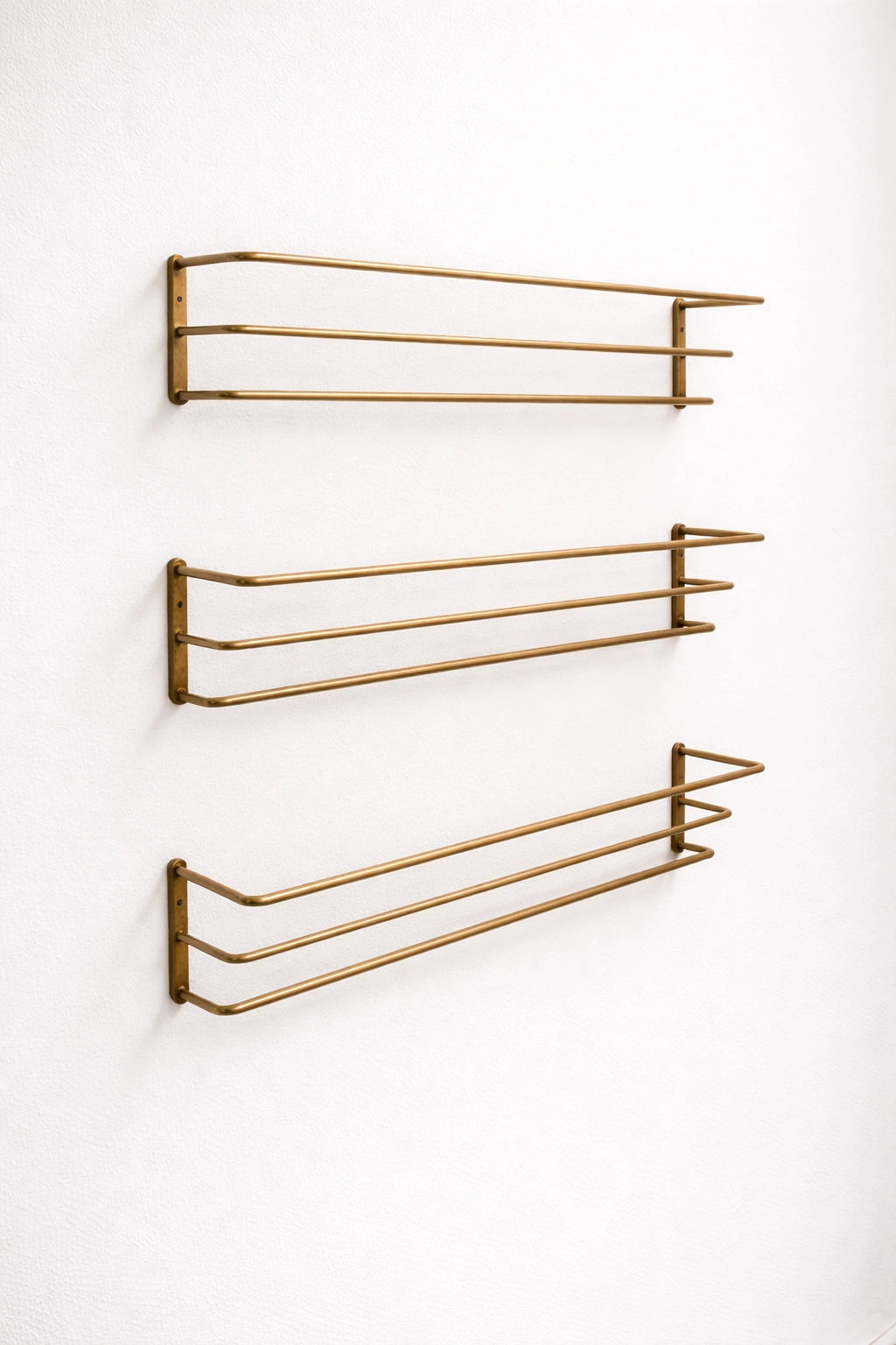Brass bottle holder with a polished finish, designed to securely store and display bottles while adding an elegant and functional touch to bars, countertops, or kitchen spaces.