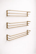 Brass bottle holder with a polished finish, designed to securely store and display bottles while adding an elegant and functional touch to bars, countertops, or kitchen spaces.