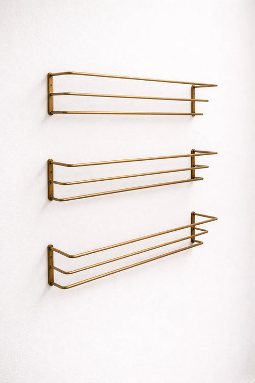 Brass bottle holder with a polished finish, designed to securely store and display bottles while adding an elegant and functional touch to bars, countertops, or kitchen spaces.