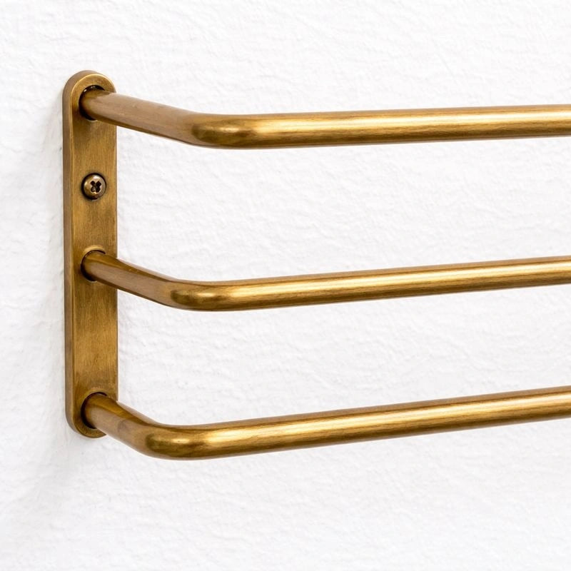 Brass bottle organizer with a polished finish, designed to neatly store and display bottles on countertops or shelves while adding an elegant and functional touch to bars or kitchens.