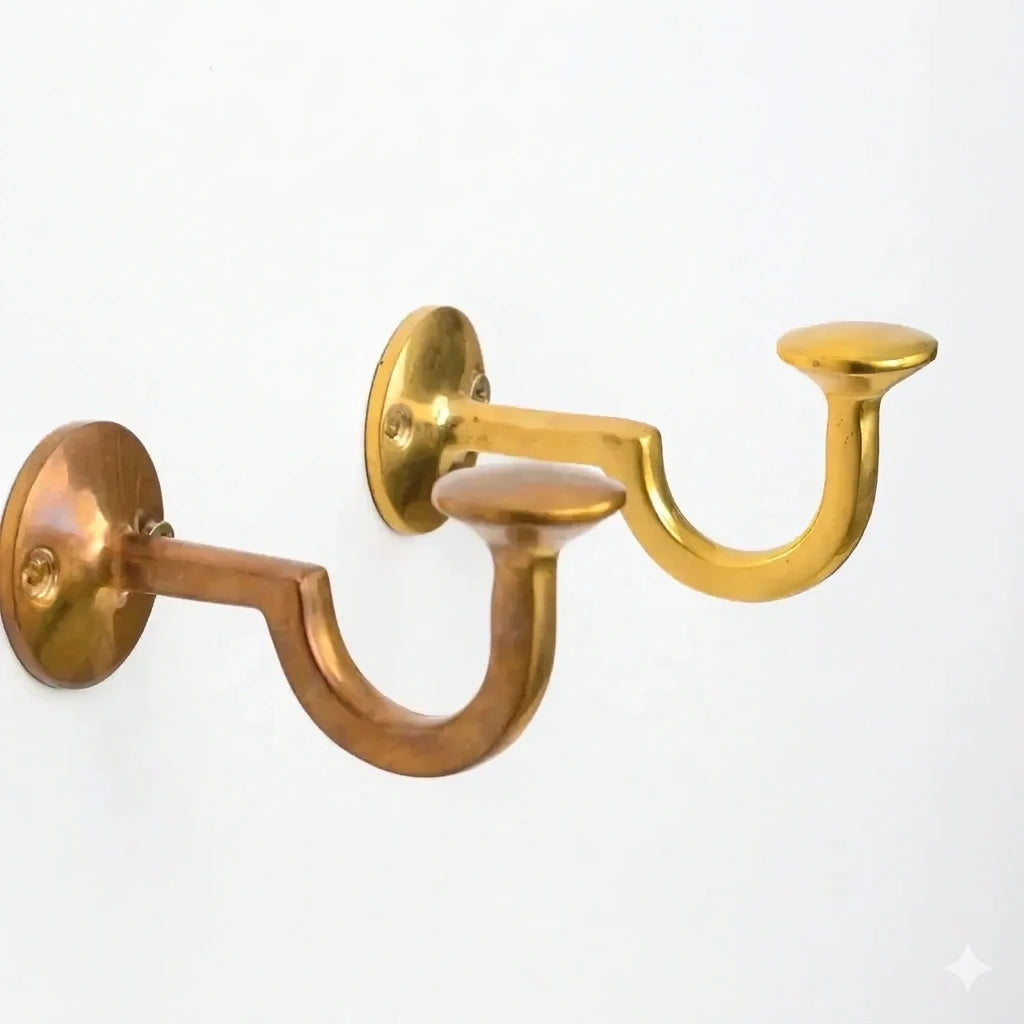 Brass hook with a polished finish, designed for securely hanging coats, bags, or accessories while adding a durable and elegant touch to walls or furniture.