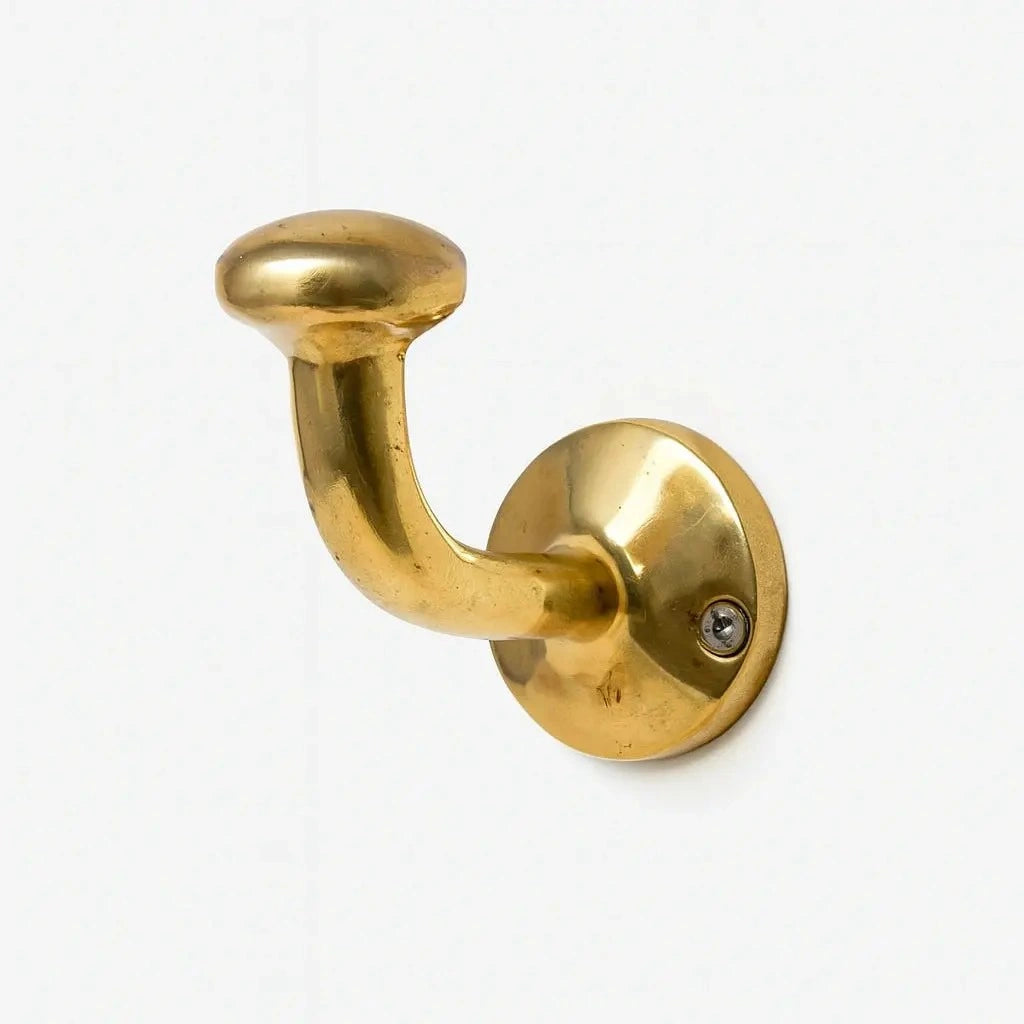 Solid brass hook for coats, towels, and purses in a bar, featuring a polished finish and sturdy construction to securely hold items while adding a stylish and durable accent to the space.
