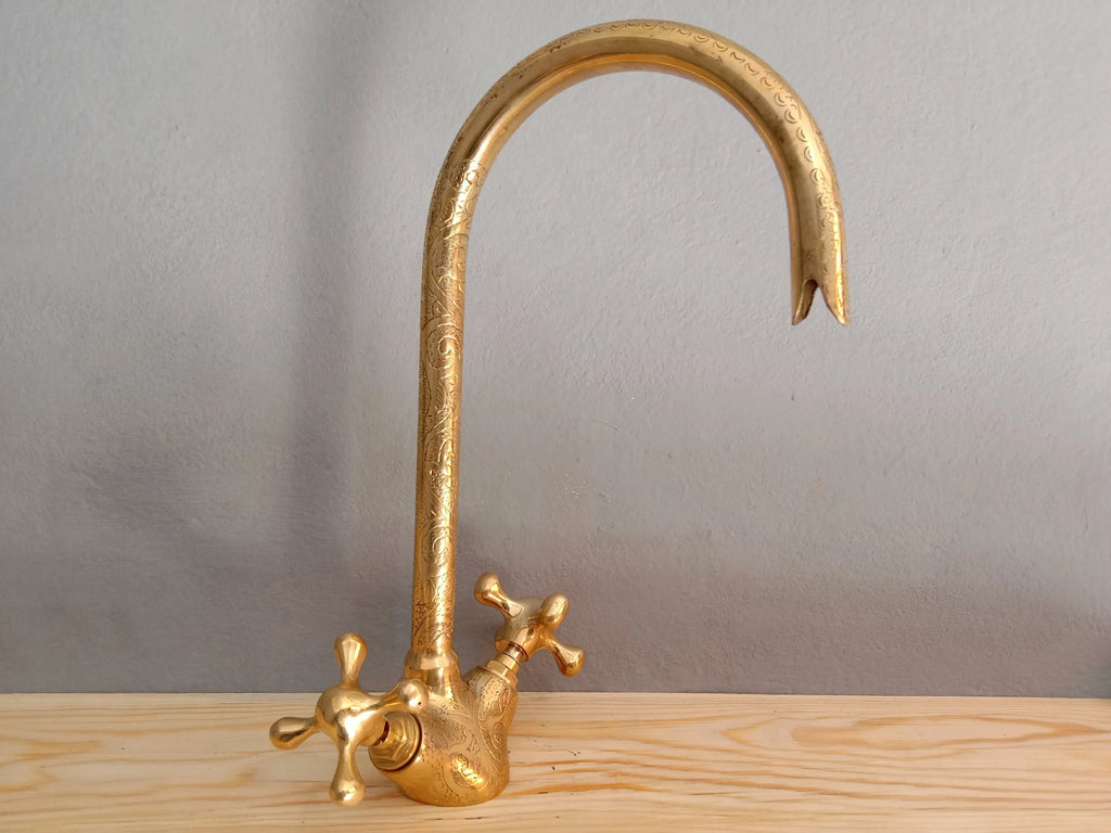 brass engraved solid goosneck faucet on a wooden table