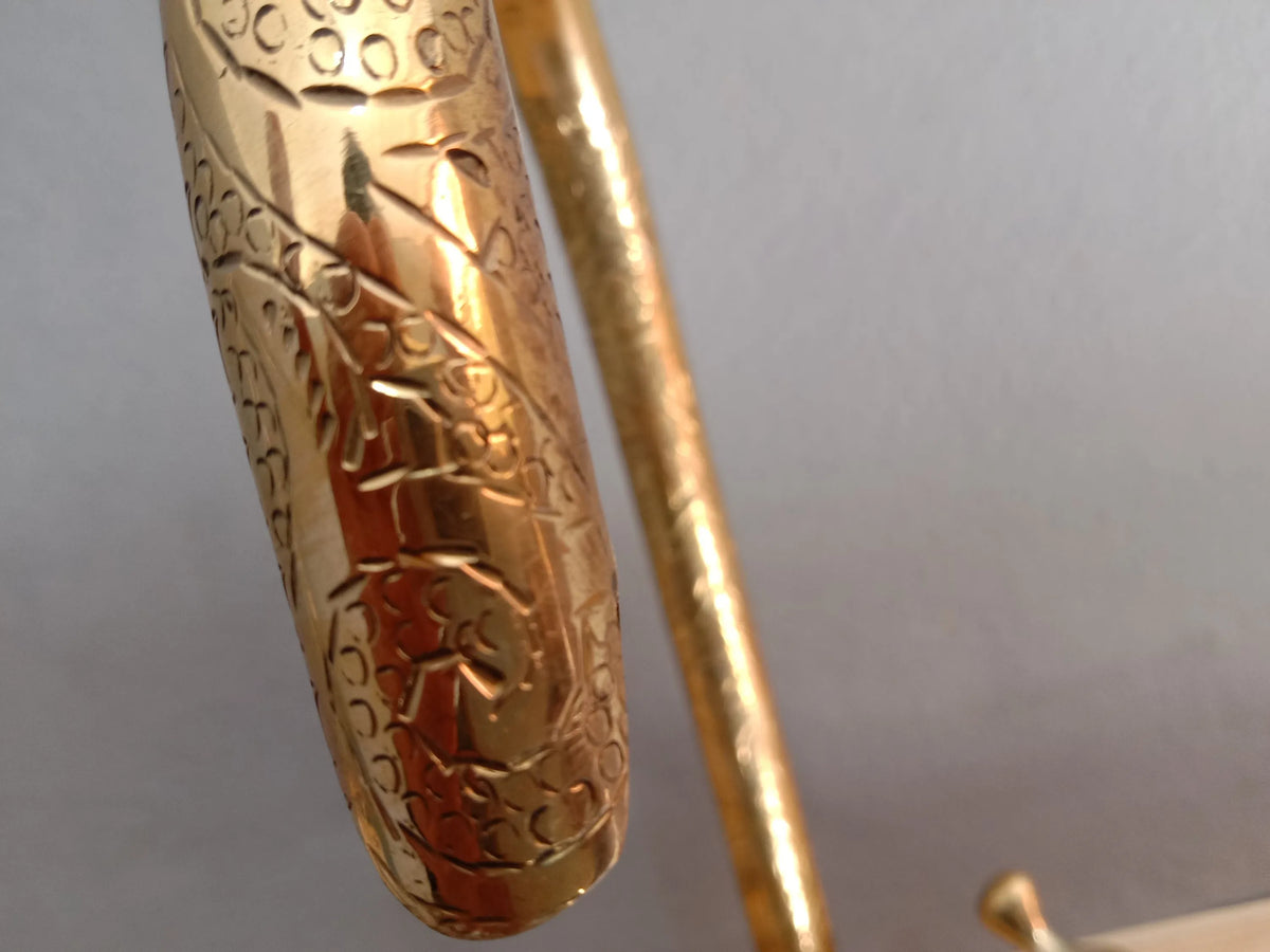 brass engraved solid goosneck faucet zoomed in picture on the engraved part 