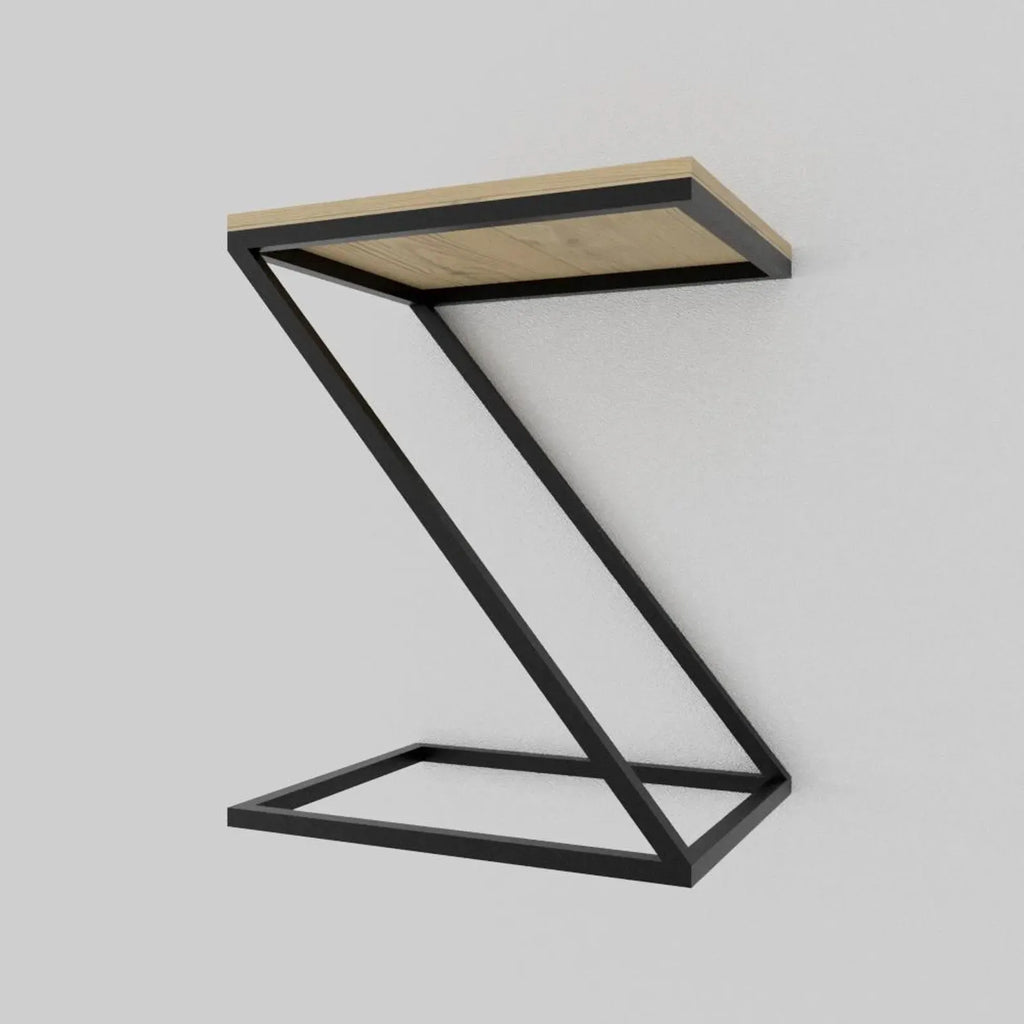 A modern Z-shaped side table featuring a light natural wood top and a black metal frame base, shown against a neutral light gray background.