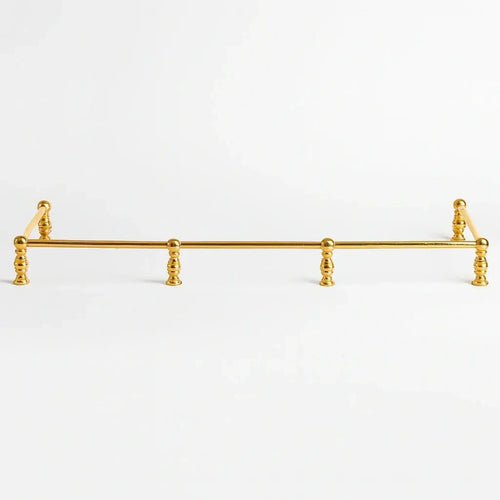 Brass bottle shelf and holder with a polished finish, designed to securely store and display bottles while adding an elegant and functional touch to any bar or countertop.