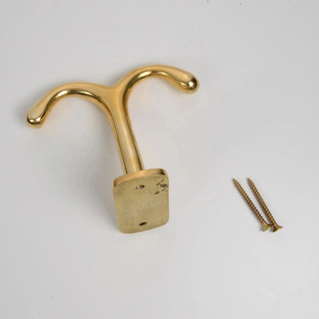 Brass ceiling double hook with 2 screws in a polished finish, designed for overhead installation to securely hang coats, bags, or accessories while maintaining a sleek and space-saving look. 