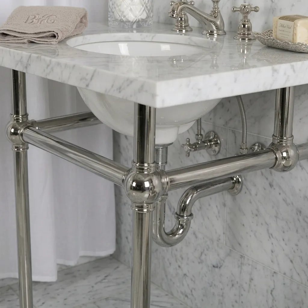 marble sink with a polished nickel console wall and floor mounted
